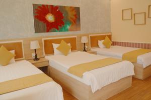 Postel nebo postele na pokoji v ubytování Sao Vang Hotel