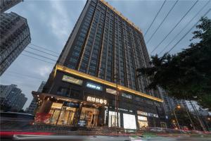 a tall building with a store in front of it at Cresasia Residence in Chengdu