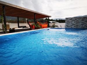 a large blue swimming pool in a house at Apolonia Boutique in Guaduas