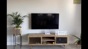 a living room with a tv on a white wall at Spectacular 2 bedroom Penthouse Apartment in Midrand
