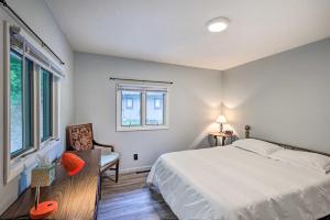 ein Schlafzimmer mit einem Bett, einem Stuhl und einem Fenster in der Unterkunft Peaceful Roan Mountain Escape On-Site Creek! in Roan Mountain