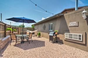 a patio with a table and chairs and an umbrella at Cañon City Home 15 Mi to Royal Gorge Bridge! in Canon City