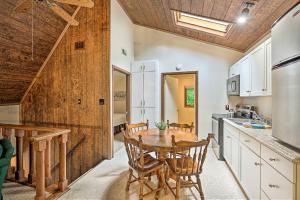 a kitchen with a wooden table and chairs in it at Charming Roan Mtn Cabin Across from Creek! in Roan Mountain