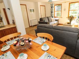 a living room with a table and a couch at Groom's Cottage in Allanton