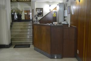 a lobby with stairs and a reception desk in a building at Hotel Almendra in Ferrol