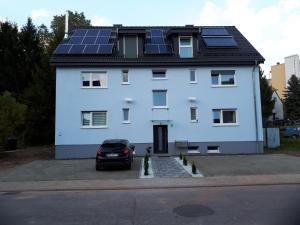 a white house with solar panels on the roof at Sarah klein aber fein in Wellesweiler
