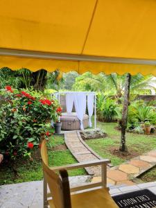 a tent in a garden with a table and flowers at Bungalow de 2 chambres avec piscine partagee terrasse et wifi a Sainte Rose in Sainte-Rose