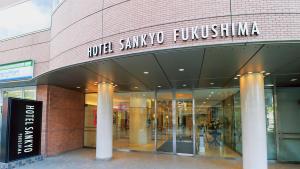 a building with a sign on the side of it at Hotel Sankyo Fukushima in Fukushima
