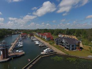 a group of boats docked at a marina on a river at Weisses Haus Plau in Plau am See