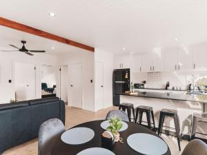 a kitchen and living room with a table and chairs at Poplar Villa - 1 Poplar Lane in Evans Head