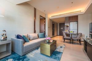 a living room with a couch and a table at Fraser Suites Dalian in Dalian