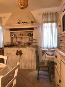a kitchen with a small table and a table and chairs at Laguna Suite B&B in Chioggia