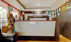 a bar in a restaurant with a statue of a woman at Sky Pie hotel in Dharamshala