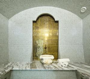 a bathroom with a tub and a sink in a room at Aisha Bibi Hotel & Spa in Astana