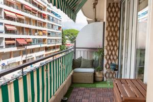 a balcony with a bench and some buildings at ´La Primavera ´ in Roquebrune-Cap-Martin