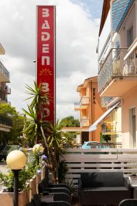 a sign for a hotel in front of a building at Hotel Baden Baden in Rimini