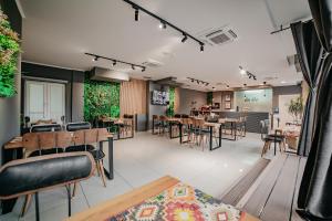 a restaurant with tables and chairs in a room at University Hotel Dorrah in Tuzla