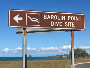 a brown sign for a barrel point dive site at Villa 21 The Coral Cove Resort in Elliott Heads