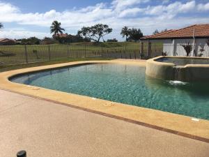 a swimming pool with a fountain in a yard at Villa 21 The Coral Cove Resort in Elliott Heads