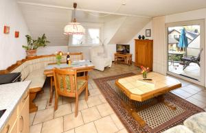 a kitchen and living room with a table and chairs at Haus Wegener in Bad Sassendorf