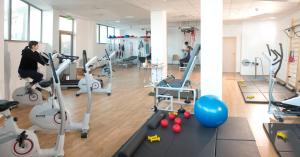 a woman in a gym with cardio machines at Sanatorium Uzdrowiskowe Bałtyk in Kołobrzeg