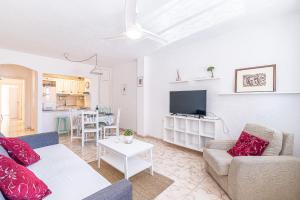 a living room with a couch and a tv at alquilaencanarias El Medano Playa El Cabezo in El Médano