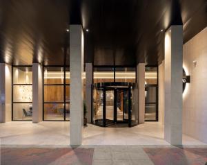 a lobby of a building with large glass doors at Hotel Ciudad de Logroño in Logroño