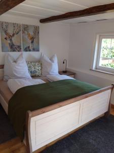 a bedroom with a large bed and a window at Historisches Aschberg Haisl Klingenthal, Terrasse, großer Garten 6 plus 2 Personen in Klingenthal