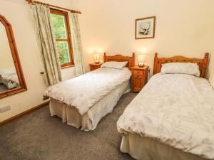 Postel nebo postele na pokoji v ubytování Gardener's Cottage