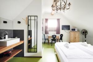 a bathroom with two beds and a sink and a mirror at HOMEBOUND APARTMENTS Salzburg City II - contactless check-in in Salzburg