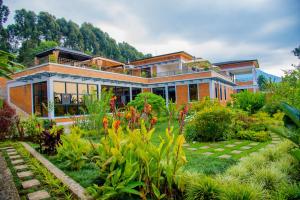 una casa con un jardín delante de ella en Virunga Inn Resort & Spa, en Kinigi