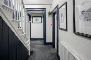 a hallway with a door leading to a hallway with a door leading to a at The Bill Nicholson Pub in London