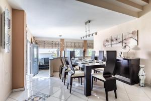 a dining room with a black table and black chairs at Althea Apartment in Skopelos Town