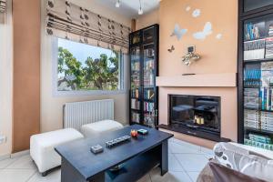 a living room with a fireplace and a table at Althea Apartment in Skopelos Town