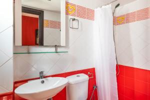 a bathroom with a sink and a toilet and a mirror at Althea Apartment in Skopelos Town +25 photos