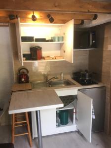 a small kitchen with a sink and a stove at Garden Annexe 2 in Villeneuve-Loubet