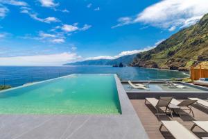 a swimming pool with a view of the ocean at Aqua Natura Bay in Porto Moniz