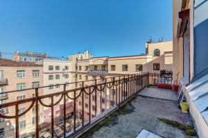 a balcony with a view of some buildings at STN Apartments by Moskovskiy Railway Station in Saint Petersburg