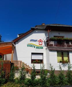 a white building with the words yews house on it at Vicky's House in Bük