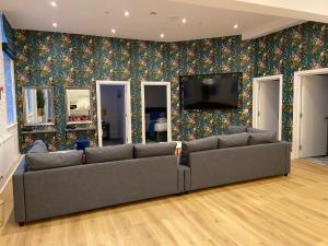 a living room with a couch and a tv at York Riverside Apartments in York