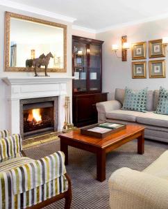 a living room with a couch and a fireplace at Premier Hotel Falstaff in Johannesburg
