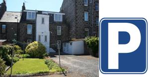 a blue parking sign in front of a house at Bimini House in Aberdeen