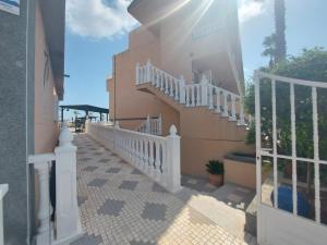 a stairway leading up to a building with a white railing at Hotel Costa Blanca Rojales in Rojales
