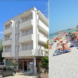 ein Gebäude neben einem Strand mit Menschen am Strand in der Unterkunft casa vacanza fronte mare fano sassonia in Fano