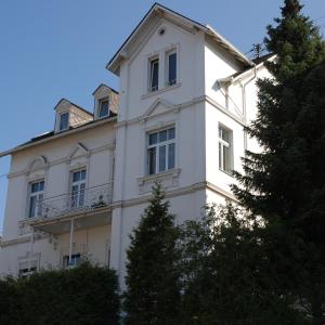 a white building with trees in front of it at White House (1f) Boppard City in Boppard