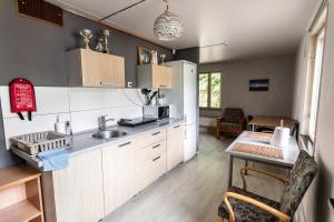 a kitchen with a sink and a table at LAKE HOUSE in Riga