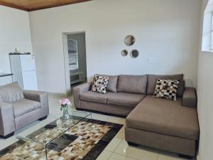 a living room with two couches and a glass table at @Anderson Executive Suites in Kimberley