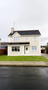 a white house on the side of a street at Modern Home Carndonagh in Carndonagh