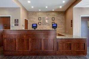 a lobby with a reception desk with two monitors at Comfort Inn & Suites Avera Southwest in Sioux Falls