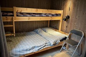 a bedroom with a bunk bed and a chair at Cabin in Trysil Mountain Arena in Trysil